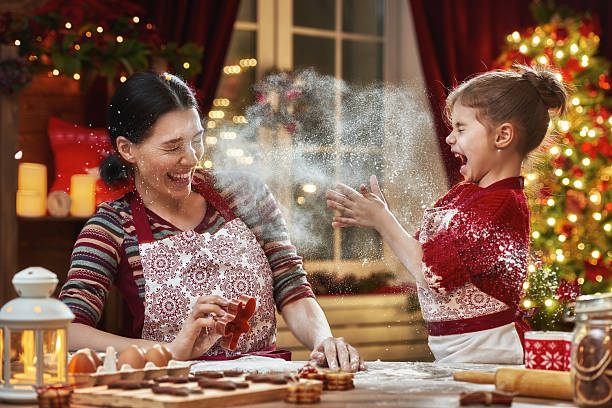 cooking Christmas cookies Merry Christmas and Happy Holidays. Family preparation holiday food. Mother and daughter cooking Christmas cookies. Christmas Tree Cookie stock pictures, royalty-free photos & images