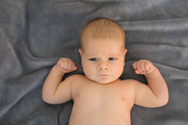 Baby showing his muscles stock photo