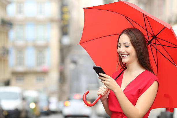 istock Woman in red texting on a smart phone 621383178