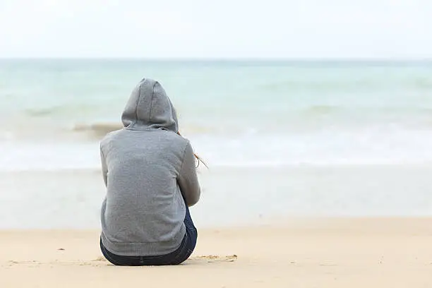 Photo of Teenager girl thinking watching the sea