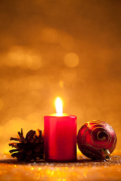 istock Candle and bauble on glitter with gold background 621383534