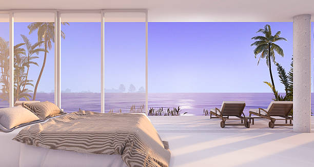 istock 3d rendering luxury villa bedroom near beach with evening scene 621384934
