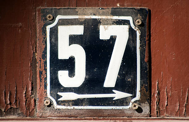 Weathered enameled plate number 57 Weathered grunge square metal enameled plate of number of street address with number 57 closeup number 58 stock pictures, royalty-free photos & images