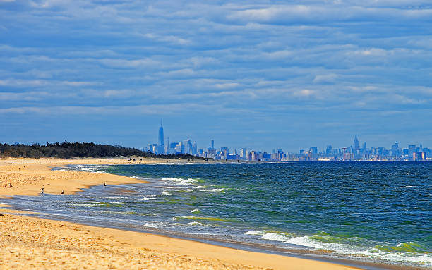 istock Atlantic Ocean shore at Sandy Hook with view to NYC 621386720