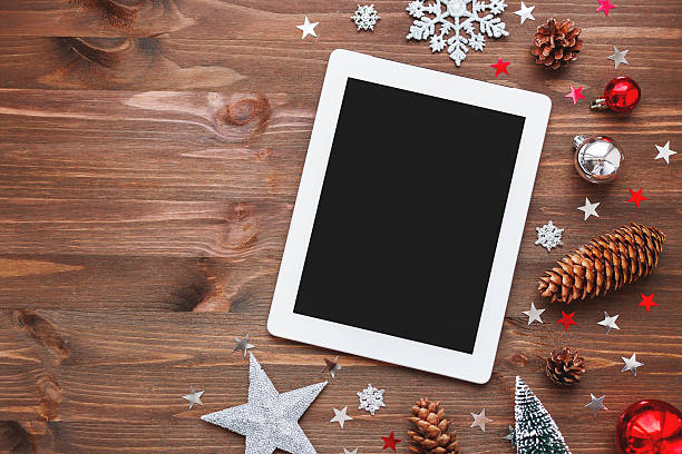istock Christmas and New Year background with tablet and decorations. 621386776