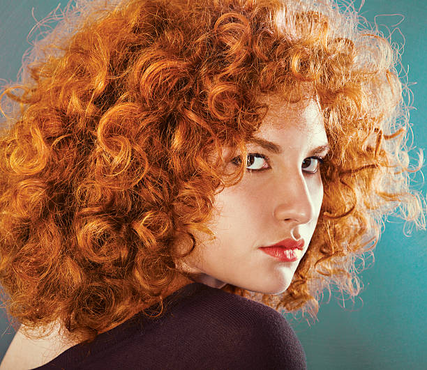 istock redhead sexy curly young woman 621387032