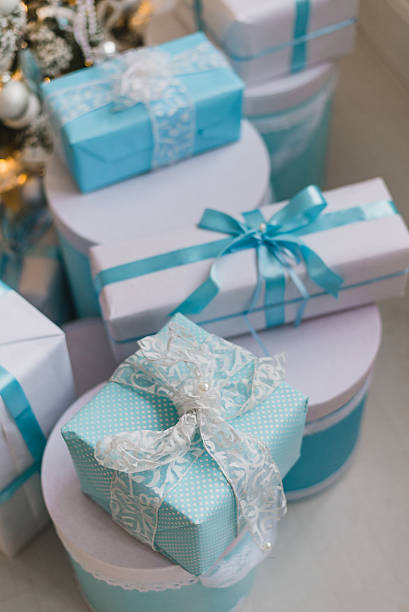 istock Christmas gift boxes with blue bow and bokeh lights on 621387544