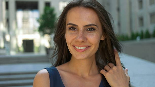 istock Adorable lady posing on camera in front of a business 621387578