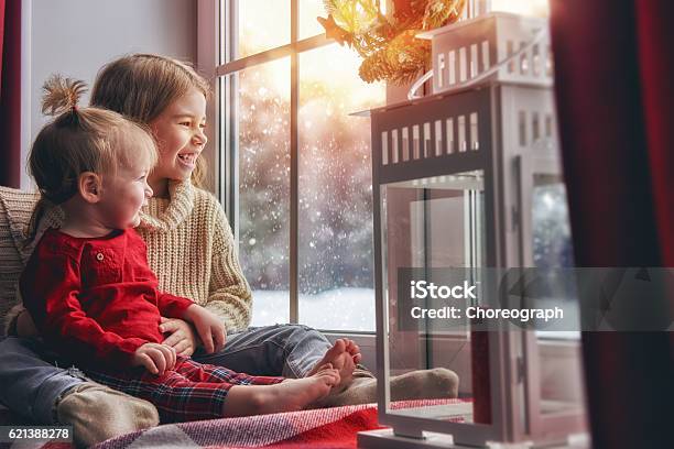 Kids Enjoy The Snowfall Stock Photo - Download Image Now - Heat - Temperature, Winter, Family