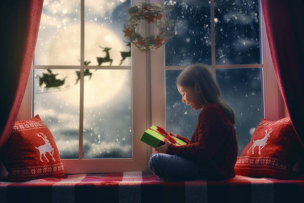 istock girl sitting by the window 621388506