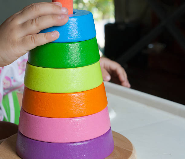 istock Wood pyramid toy with baby hand 621389340