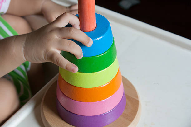 istock Wood pyramid toy with baby hand 621389466
