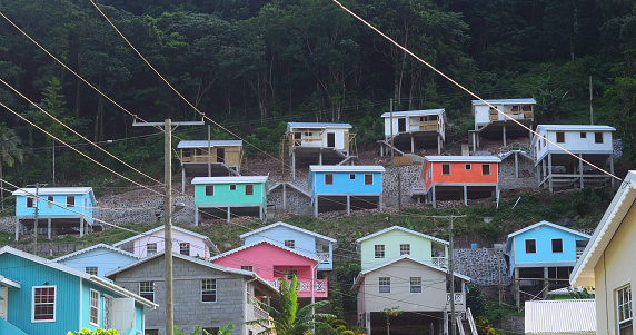 colorful quaint caribbean homes in housing development with electric poles and lines visible