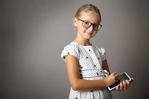 Little girl writes on the Tablet isolated image of Little girl writing on Tablet lavagna stock pictures, royalty-free photos & images