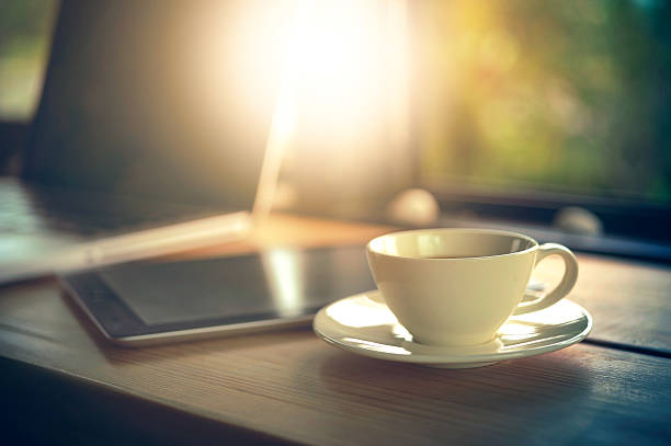 istock Laptop tablet and white coffee cup on wooden table 621393770