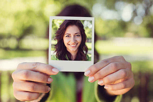 istock Girl showing instant photo 621463876
