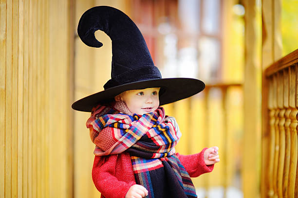 istock Toddler boy in pointed hat playing outdoors 621464366
