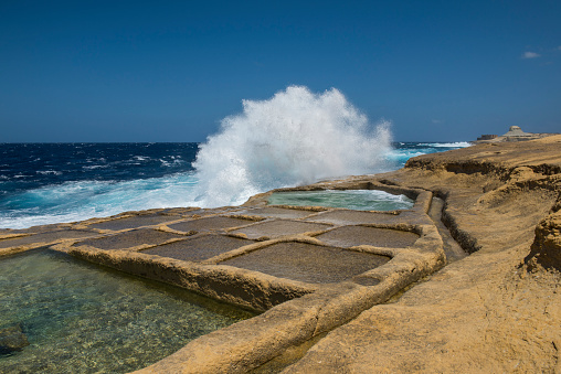 Waves breaking over the Salt pans on Xwejni bay - Maltese island Gozo