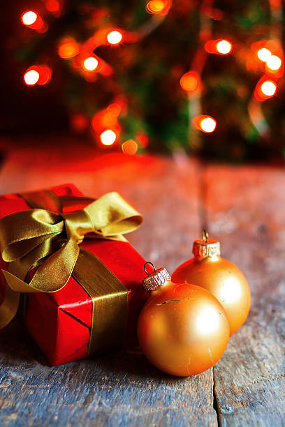istock wrapped gift on the background of Christmas lights 621464824