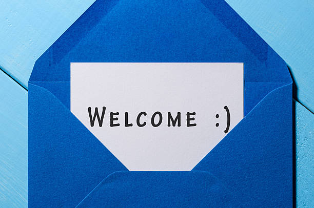 istock Welcome inscription. Hand drawn letter in blue envelope 621465648