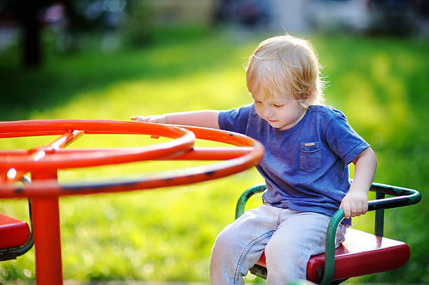 istock Toddler boy having fun on playground 621466772