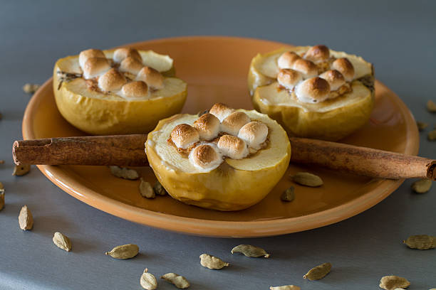istock Appetizing baked apples with cottage cheese, cinnamon and marshmallows 621467800