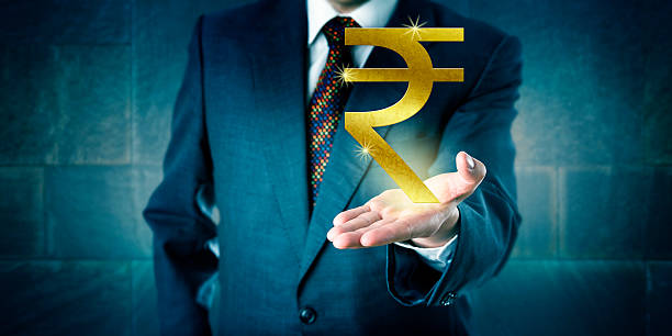 Businessman Offering A Golden Indian Rupee Symbol stock photo
