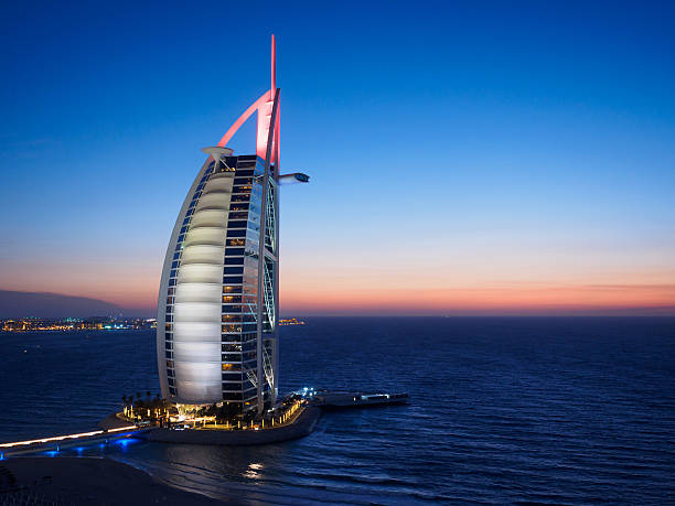 Burj Al Arab Jumeirah at night. Dubai, United Arab Emirates - April 16, 2016: A view of the Burj Al Arab Hotel at night.  The Burj Al Arab is one of the iconic landmarks of Dubai and is one of the worlds most luxurious hotels with a 7 star rating.  The hotel is owned and operated by the Jumeirah Group. jumeirah stock pictures, royalty-free photos & images