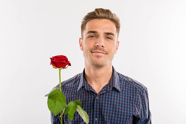 istock Romantic man gives a red rose 621470478