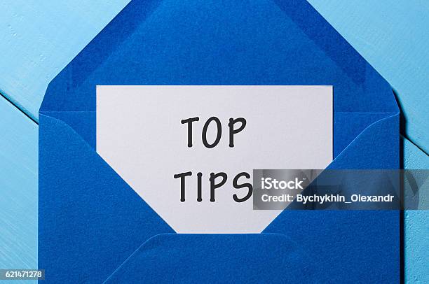 Text Top Tips On Paper In Blue Envelope Business Concept Stock Photo - Download Image Now