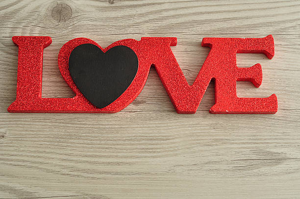 istock Love in red letters with a small black heart 621471826