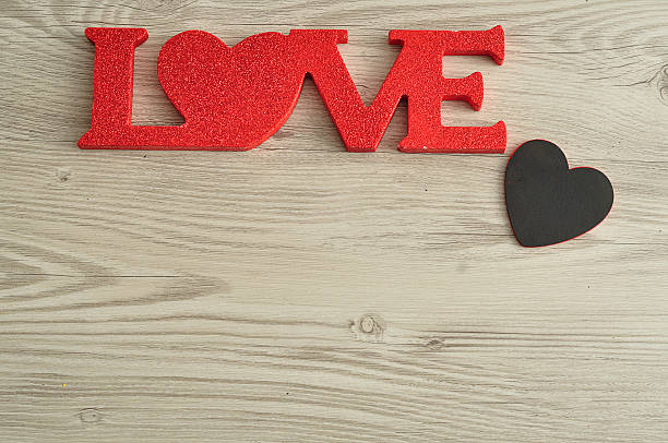 istock Love in red letters with a small black heart 621472034