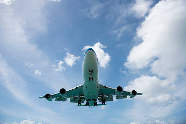 Maho Beach, Saint Maarten - November 17, 2015: A KLM Boeing 747 descends over Maho Beach moments before touching down at Princess Juliana International Airport in St. Maarten.