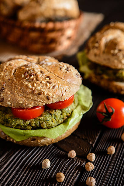 istock Vegetable burger with chickpeas - spinach fritter, lettuce and tomato 621474748