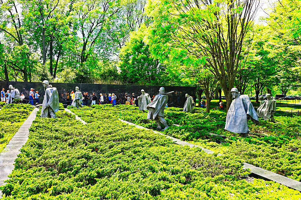 Washington DC, USA - May 2, 2015: Tourists and War Veterans and guardians of Honor Flight nonprofit organization in Korean War Veterans Memorial in West Potomac Park, the National Mall.