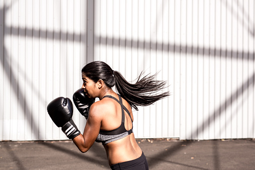 Woman boxing with special gloves