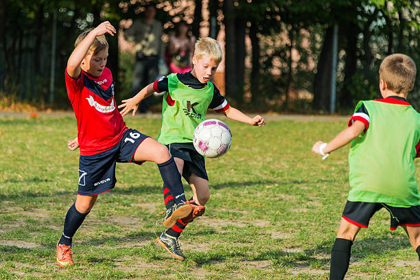 Boys play football on the sports field Lviv, Ukraine - September 30, 2016:  Boys playing football on city football championship among school teams  Lviv. club football stock pictures, royalty-free photos & images