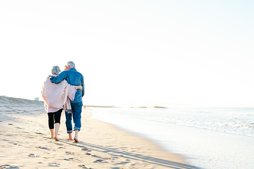 Senior's couple walking on the beach