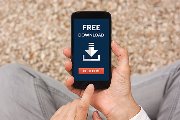 istock Hands holding smart phone with free download concept on screen 621476348