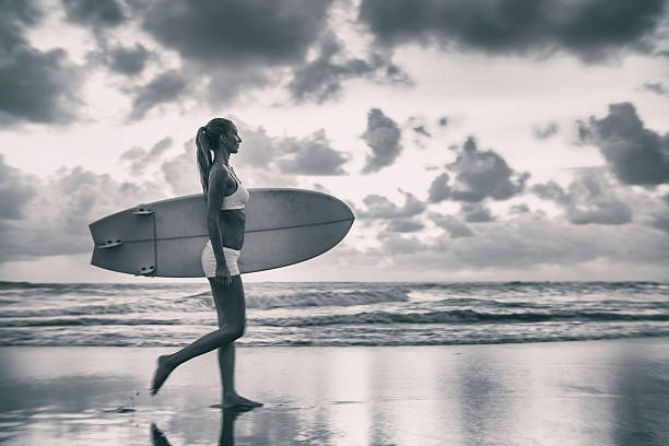 istock Caucasian woman with surfboard on the beach going to surf 621477940