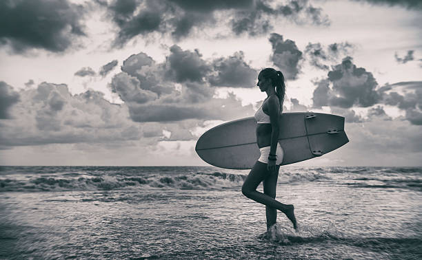 istock Caucasian woman with surfboard on the beach going to surf 621478002
