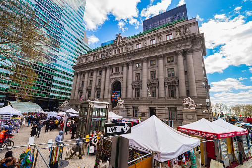 New York City, USA - April 24, 2015: Street view on Alexander Hamilton US Custom House, Lower Manhattan, New York, USA. Now it is the National Museum of American Indians. Tourist nearby