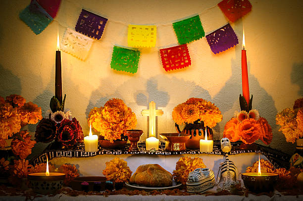 Mexican day of the dead altar "Dia de Muertos" Traditional mexican Day of the dead altar with cempasuchil flowers, bread "pan de muerto", "papel picado" ornaments and candles. altar photos stock pictures, royalty-free photos & images