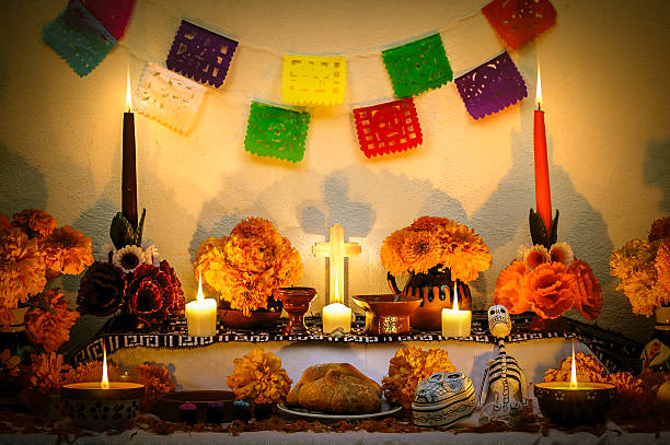 Mexican day of the dead altar "Dia de Muertos" Traditional mexican Day of the dead altar with cempasuchil flowers, bread "pan de muerto", "papel picado" ornaments and candles. altar stock pictures, royalty-free photos & images