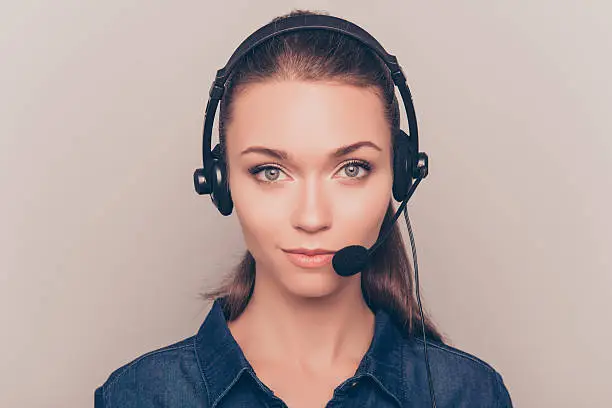 Portrait of young attractive minded woman in call center