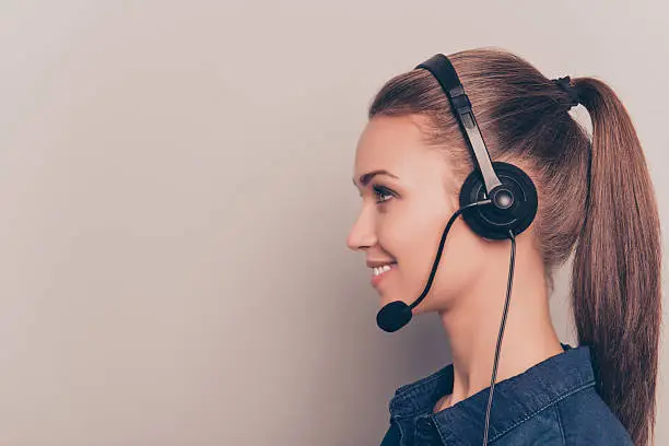 Side view portrait of cheerful girl in headphones with microphone