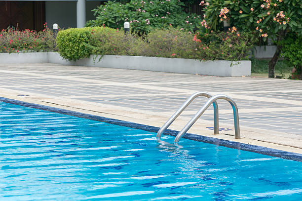 istock Swimming pool with stair at hotel close up 621485566