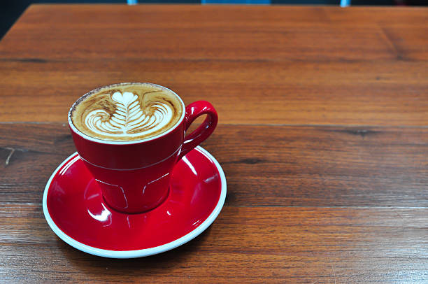 istock red Cup of coffee on a wooden table 621487062