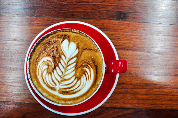 red Cup of coffee on a wooden table Coffee cup in coffee shop,red Cup of coffee on a wooden table,cup of coffee on table in cafe,cup of cappuccino black coffee swirl stock pictures, royalty-free photos & images