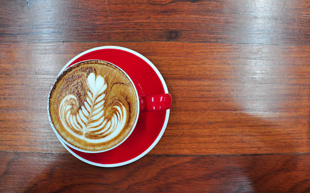 red Cup of coffee on a wooden table Coffee cup in coffee shop,red Cup of coffee on a wooden table,cup of coffee on table in cafe,cup of cappuccino black coffee swirl stock pictures, royalty-free photos & images